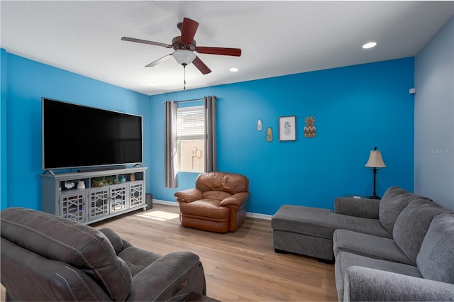 living area featuring recessed lighting, a ceiling fan, baseboards, and wood finished floors