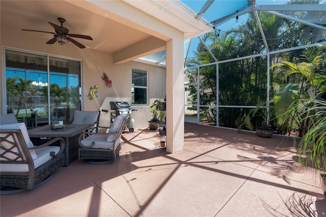 view of patio / terrace with a grill, a lanai, and a ceiling fan