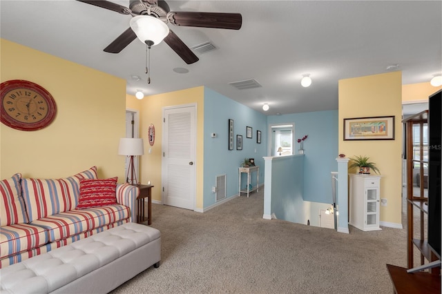 carpeted living area featuring visible vents and baseboards