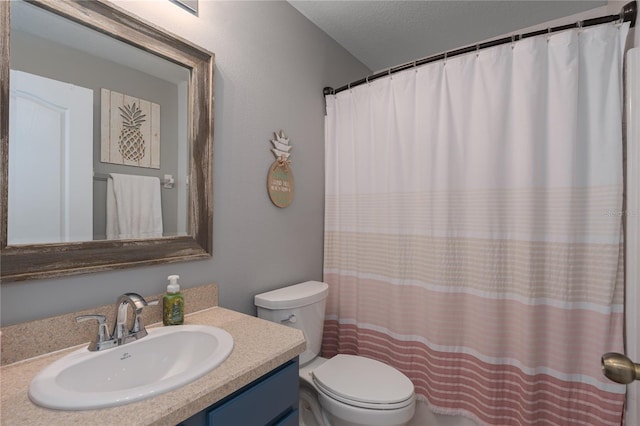 full bathroom featuring curtained shower, toilet, vanity, and a textured ceiling