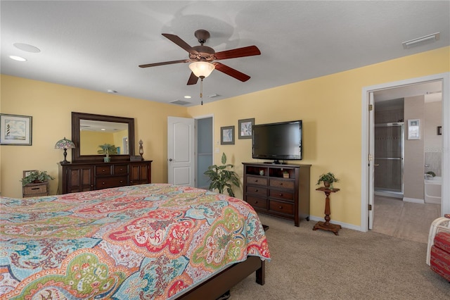 bedroom with a ceiling fan, baseboards, visible vents, ensuite bath, and carpet flooring