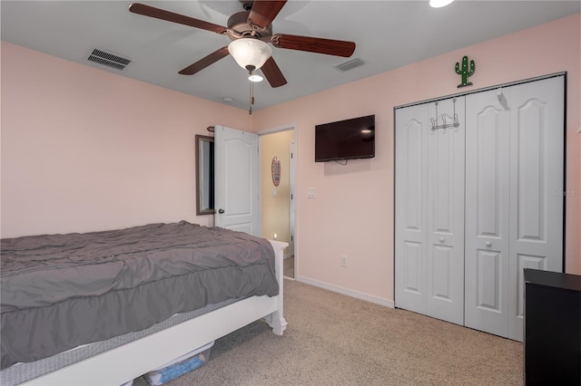 bedroom with visible vents, baseboards, light colored carpet, and a closet