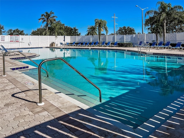 community pool featuring a patio and fence