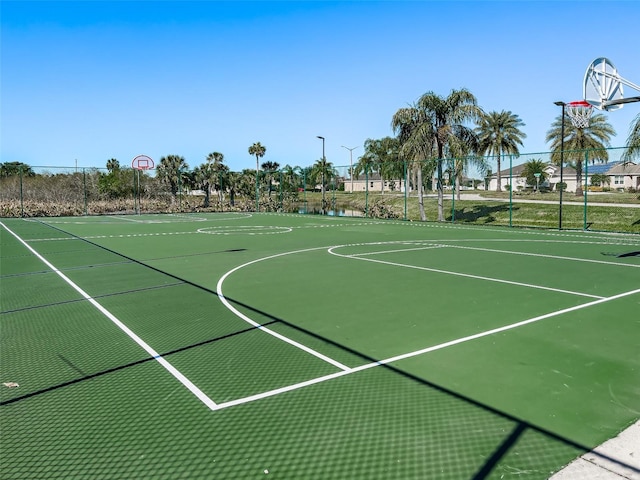 view of basketball court with community basketball court and fence