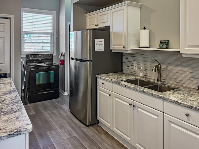 kitchen featuring a sink, open shelves, freestanding refrigerator, black electric range oven, and dark wood-style flooring