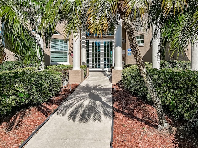 entrance to property featuring stucco siding and french doors