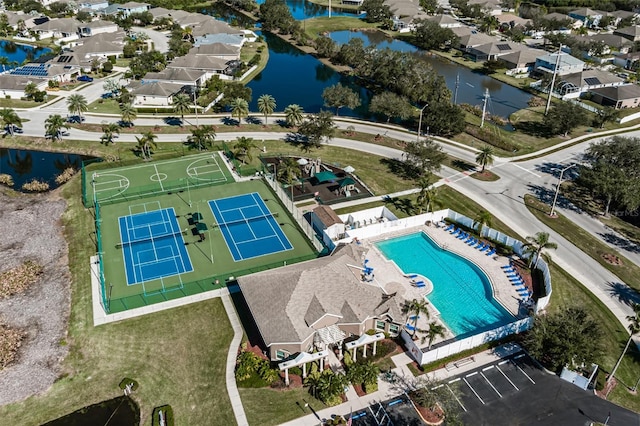 drone / aerial view featuring a residential view and a water view