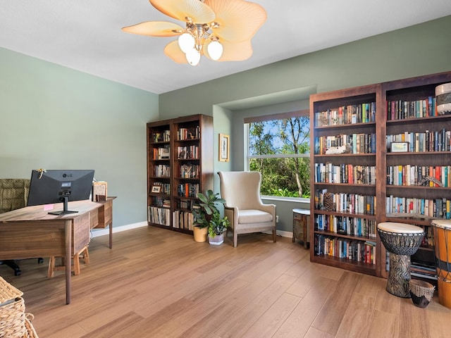 office area featuring ceiling fan, baseboards, and wood finished floors