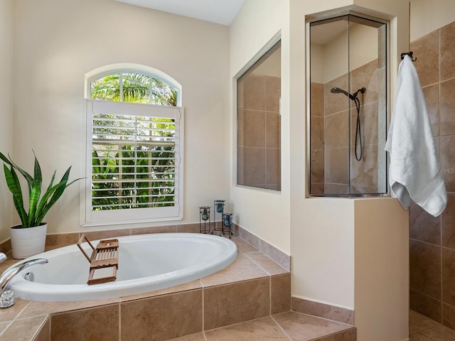 full bathroom featuring a bath and walk in shower