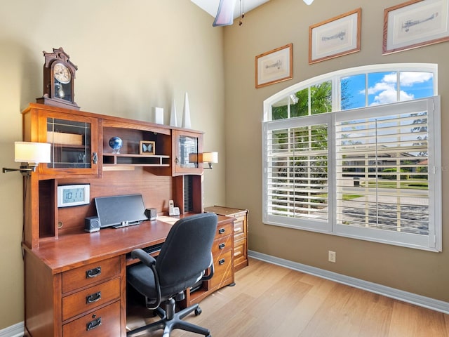 home office featuring baseboards and light wood-style floors