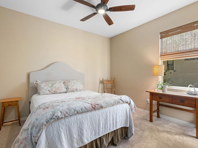 bedroom featuring baseboards, light carpet, and ceiling fan