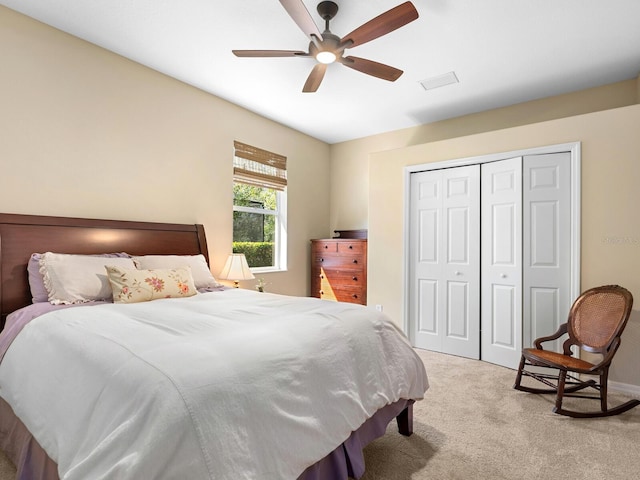 carpeted bedroom with a closet and ceiling fan