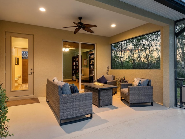 view of patio featuring an outdoor living space with a fire pit and a ceiling fan