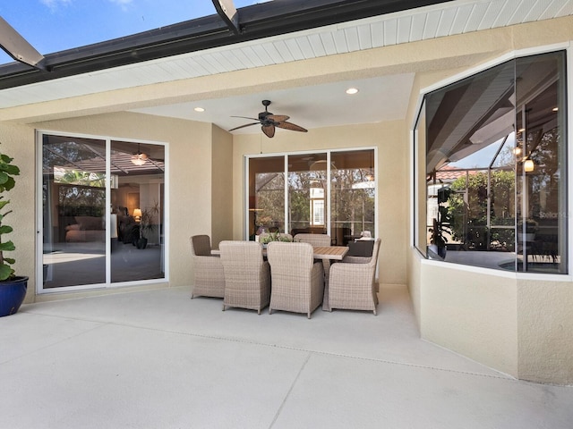 view of patio / terrace featuring a lanai, outdoor dining area, and ceiling fan