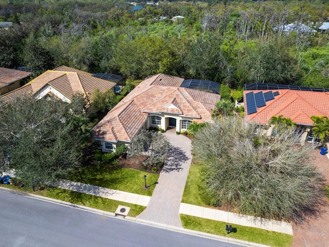 birds eye view of property featuring a view of trees