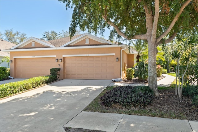7317 Emma Rd, Bradenton, FL 34209 - view of front facade with an attached garage, concrete driveway, and stucco siding