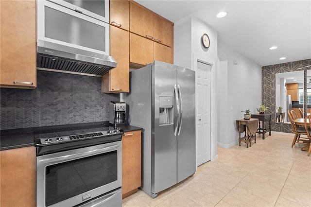 kitchen with dark countertops, appliances with stainless steel finishes, decorative backsplash, and recessed lighting