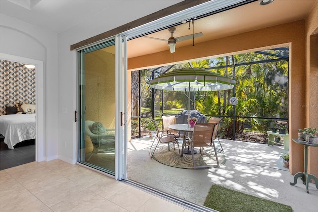 entryway featuring a wealth of natural light, a sunroom, and tile patterned floors