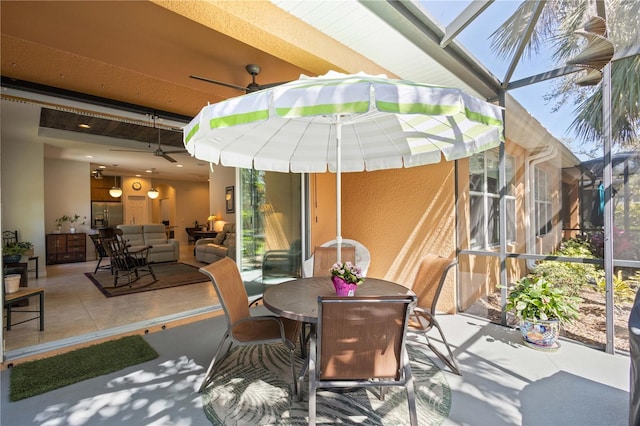 view of patio / terrace with outdoor dining area, outdoor lounge area, a lanai, and a ceiling fan