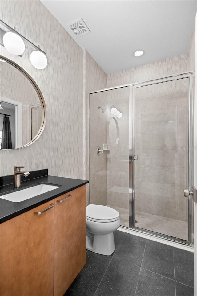 full bath featuring visible vents, toilet, a stall shower, vanity, and wallpapered walls