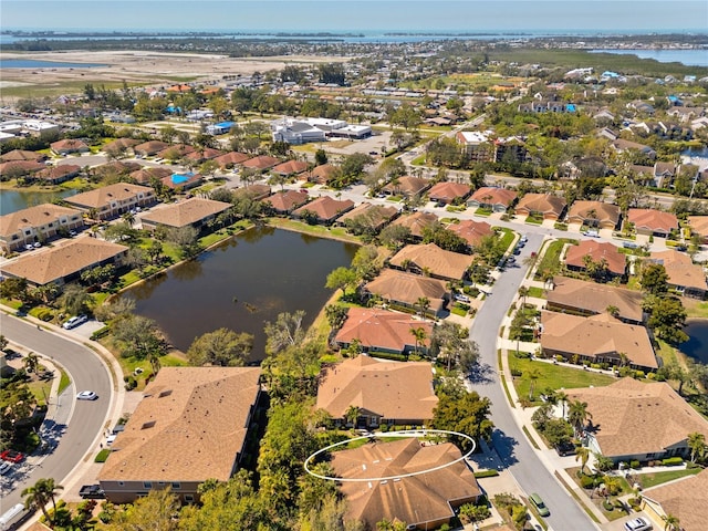 bird's eye view featuring a water view and a residential view