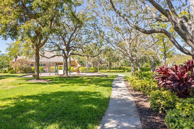 surrounding community featuring a lawn and playground community