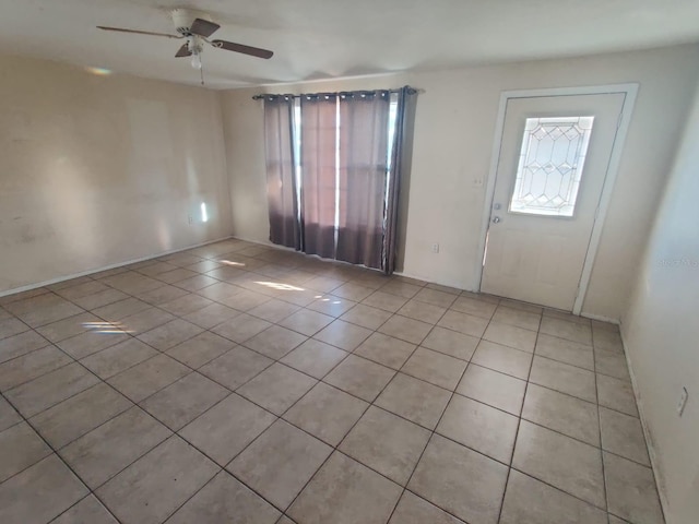 entryway featuring ceiling fan and light tile patterned floors