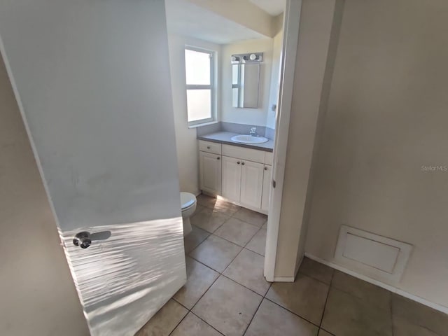 bathroom featuring vanity, toilet, and tile patterned floors