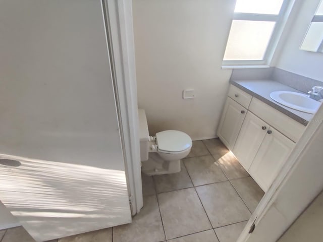 bathroom featuring toilet, tile patterned flooring, and vanity