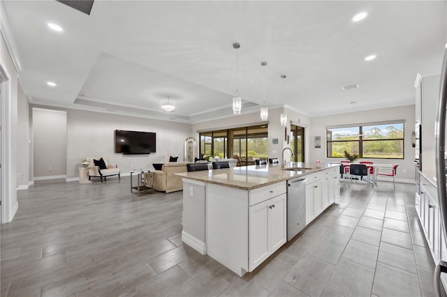 kitchen with dishwasher, an island with sink, light stone countertops, white cabinetry, and a sink