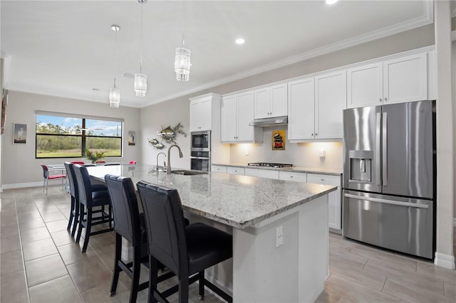 kitchen featuring a center island with sink, white cabinets, stainless steel appliances, under cabinet range hood, and a sink