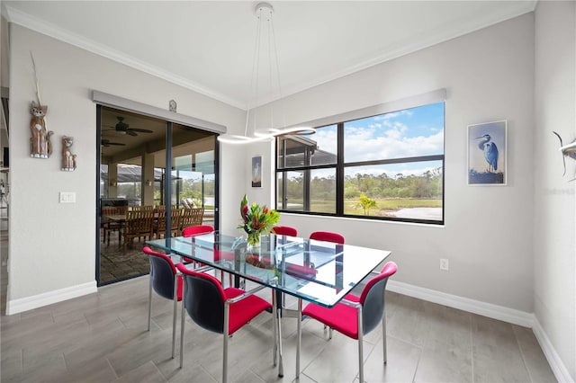 dining room featuring ornamental molding and baseboards