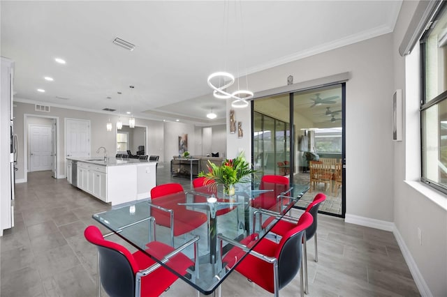 dining room featuring ornamental molding, visible vents, and baseboards