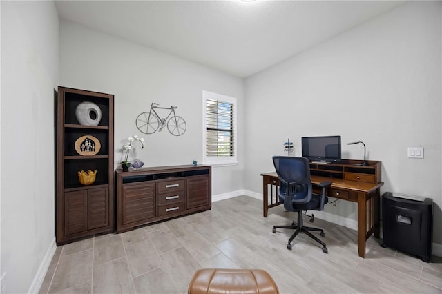 office space with light wood finished floors and baseboards