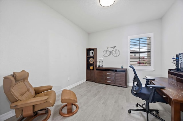 home office featuring light wood-type flooring and baseboards