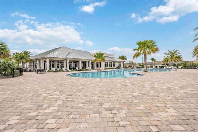 pool featuring a patio area and fence