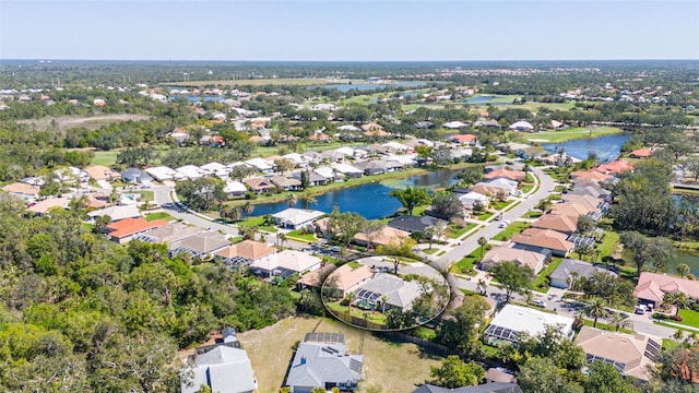 birds eye view of property with a water view and a residential view