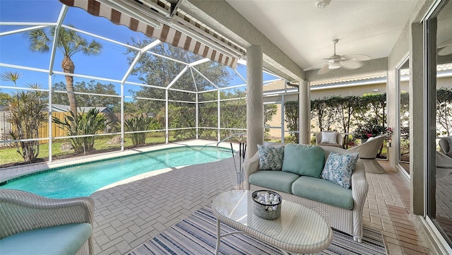 pool featuring a lanai, a patio, an outdoor hangout area, and ceiling fan