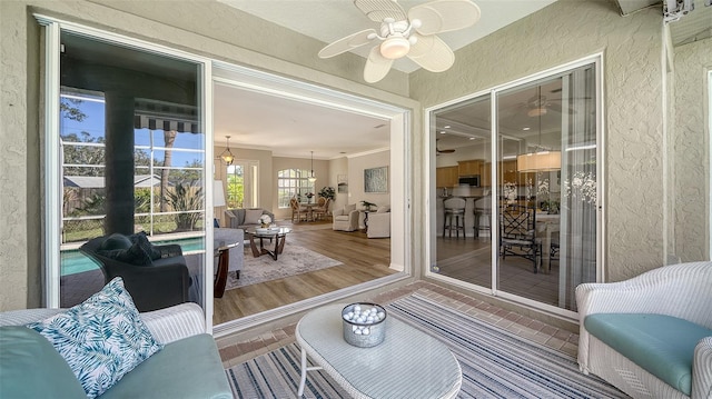 sunroom with a ceiling fan