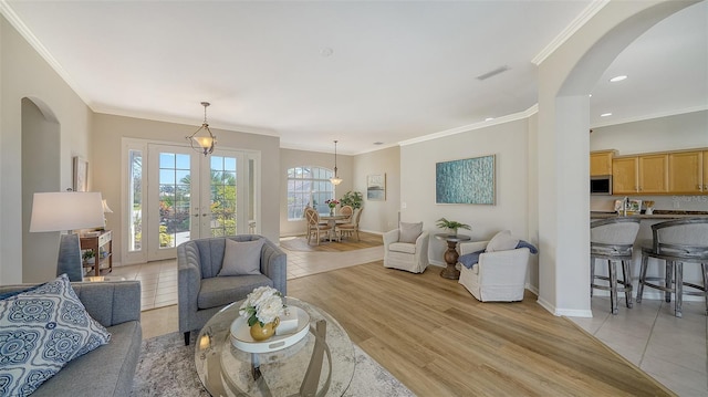 living room featuring visible vents, french doors, light wood-style flooring, and baseboards