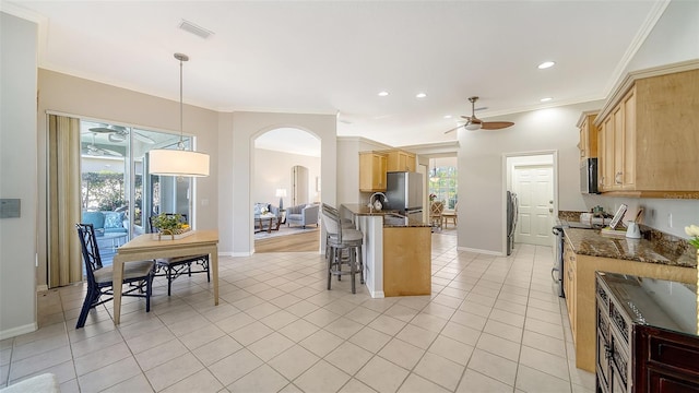 kitchen featuring arched walkways, light tile patterned flooring, visible vents, ornamental molding, and electric range oven