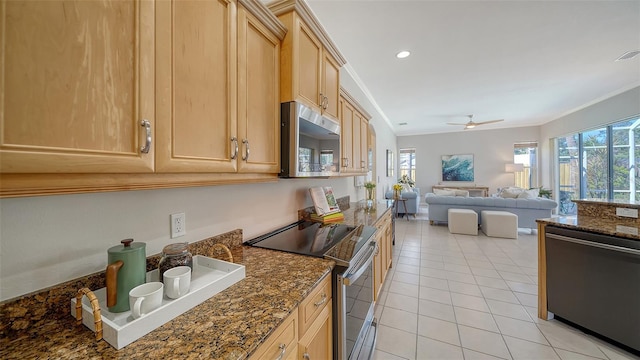 kitchen with light tile patterned flooring, light brown cabinets, stainless steel appliances, open floor plan, and ornamental molding