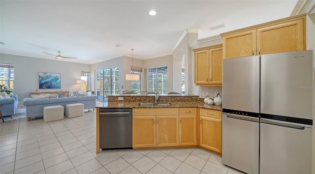 kitchen with light tile patterned floors, appliances with stainless steel finishes, a sink, and a healthy amount of sunlight