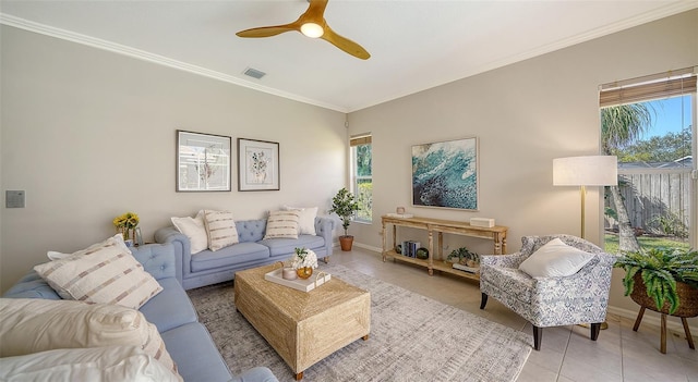 living area with light tile patterned floors, a wealth of natural light, visible vents, and crown molding