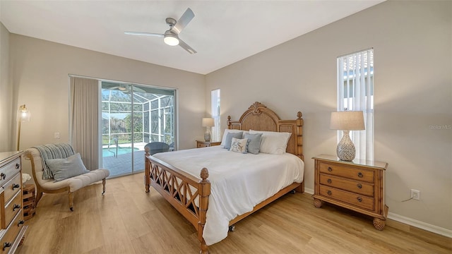 bedroom featuring access to exterior, light wood-style flooring, a ceiling fan, a sunroom, and baseboards