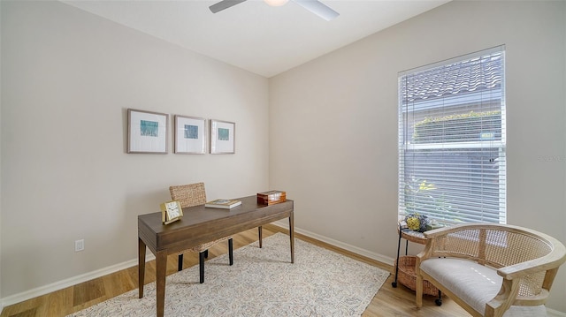 office space featuring light wood-style flooring, baseboards, and ceiling fan