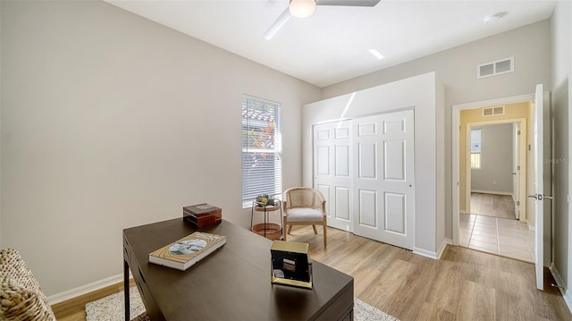 home office with light wood-type flooring, baseboards, and visible vents