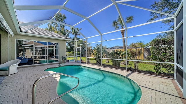 pool featuring a lanai and a patio