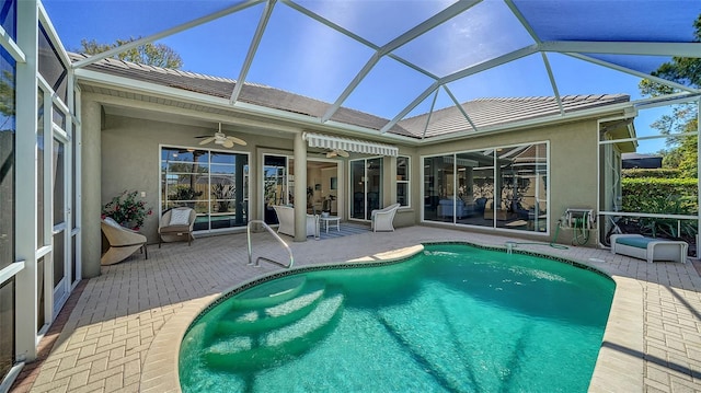 outdoor pool with ceiling fan, a patio area, and a lanai