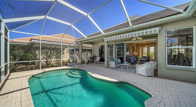 outdoor pool featuring a lanai, a patio, and ceiling fan